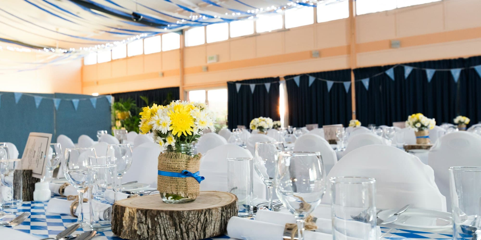 Wedding reception hall decorated for a celebration, where the right placement for an audio guestbook phone doubles recording counts